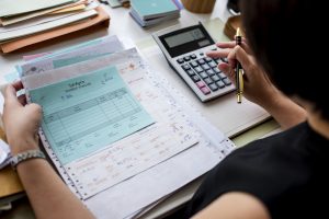 asian-woman-working-through-paperwork